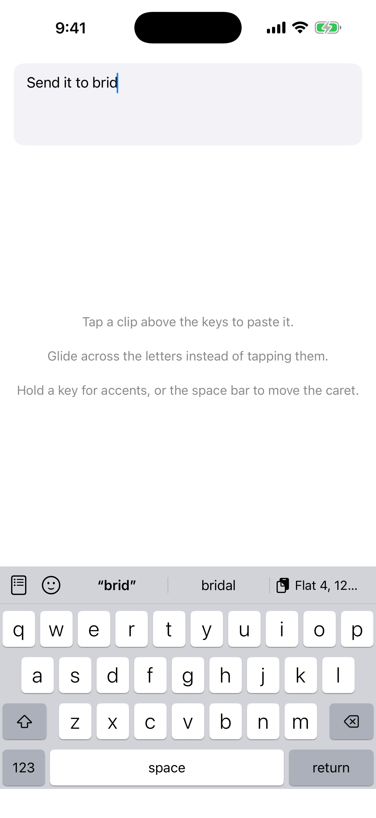 The UniClip keyboard on iPhone. The message field reads “Send it to brid”, and the row above the keys shows the completion “brid”, the suggestion “bridal”, and a saved clip reading “Flat 4, 12…” with a clipboard icon.